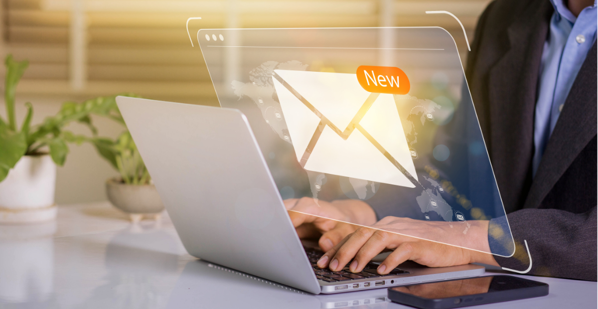 Business person using laptop with new email notification interface.